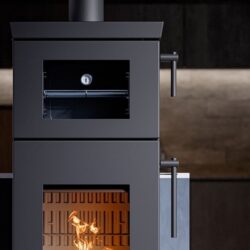 Modern stove with a focus on details: visible door handles, thermometer and blazing fire in a dark gray housing.