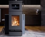Modern wood-burning stove with visible flames and adjacent oven compartment displayed in a stylish kitchen.