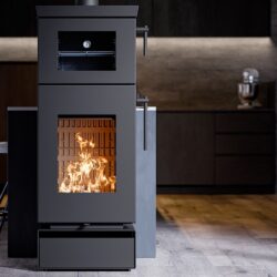 Modern wood-burning stove with visible flames and adjacent oven compartment displayed in a stylish kitchen.