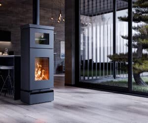 Modern stove in a stylish room with large windows, black housing and visible flames.