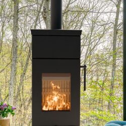 Detailed view of a black stove with visible fire, below a forest landscape through a large window.