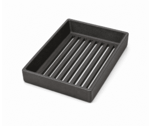 Black rectangular cast iron grate with parallel slots, photographed slightly from above. Suitable as an accessory for wood-burning stoves.
