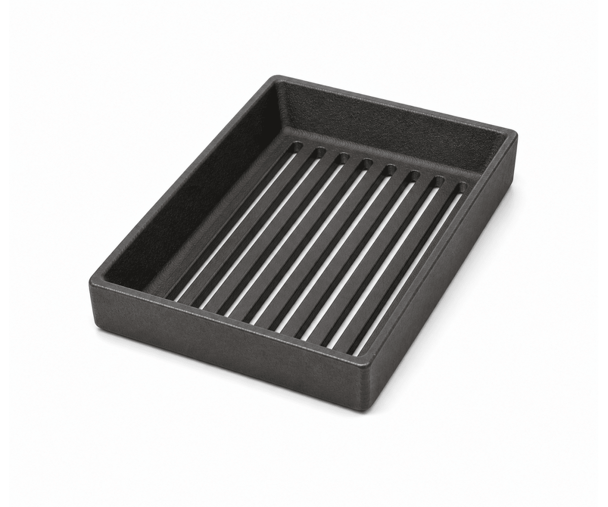 5567207000_gallery_01 Black rectangular cast iron grate with parallel slots, photographed slightly from above. Suitable as an accessory for wood-burning stoves.