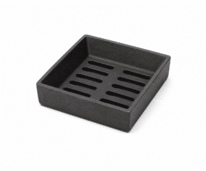 Square cast iron grate with slots, slightly raised, on a white background. Ideal as an accessory for wood-burning stoves.