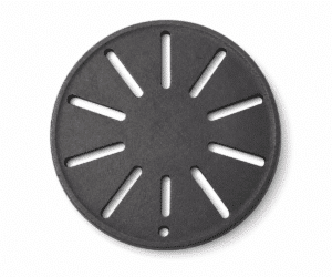 A round, black cast-iron plate with radial slits and a small hole at the edge.