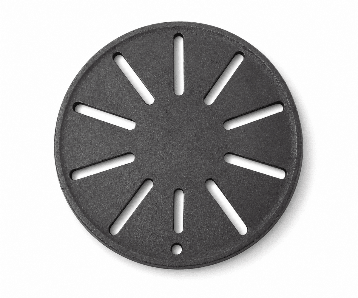 55019_gallery_01 A round, black cast-iron plate with radial slits and a small hole at the edge.
