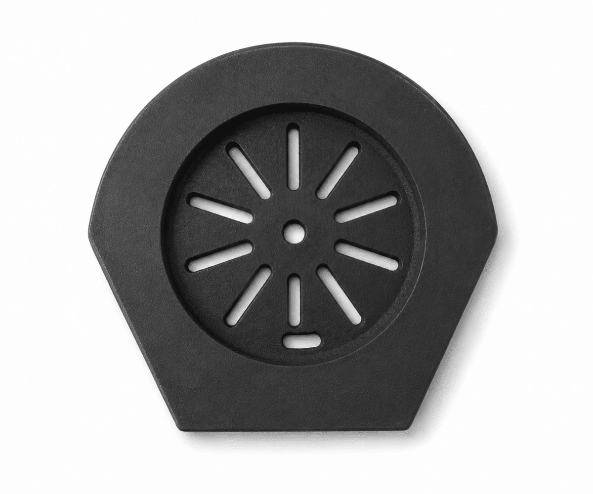 55555_gallery_01 A black, hexagonal cast-iron part with rounded edges and radial slits in the center. Suitable as an accessory for wood-burning stoves.